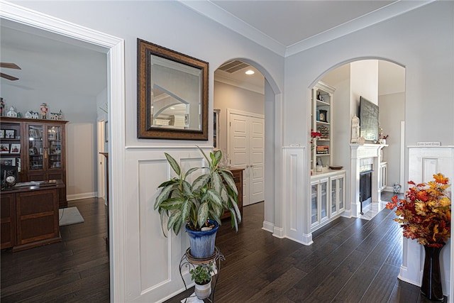 corridor featuring dark wood-type flooring and ornamental molding