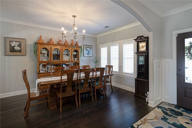 dining area with dark hardwood / wood-style floors, ornamental molding, and a chandelier