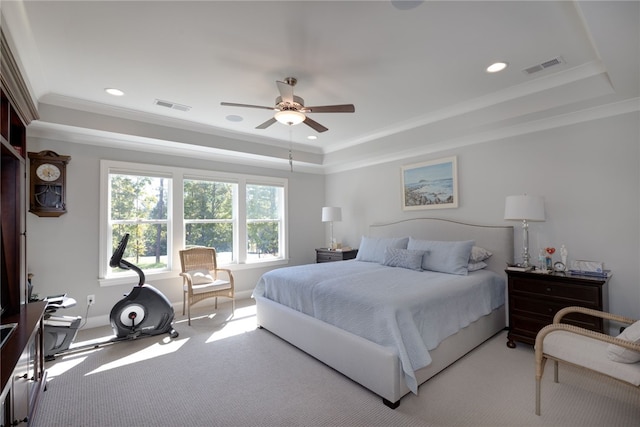 carpeted bedroom featuring a raised ceiling, ceiling fan, and crown molding