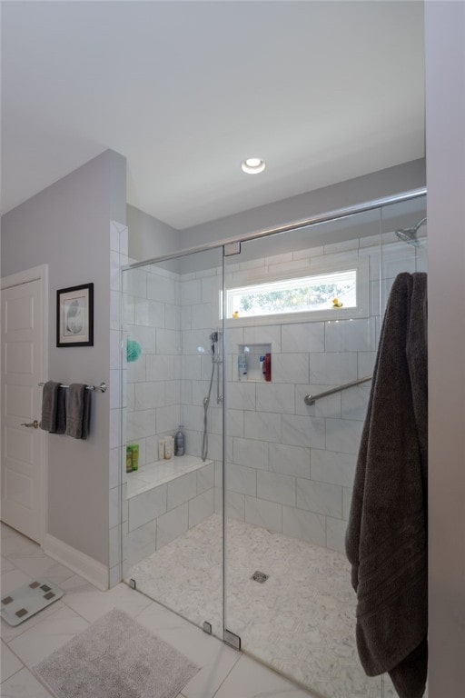 bathroom featuring a shower with door