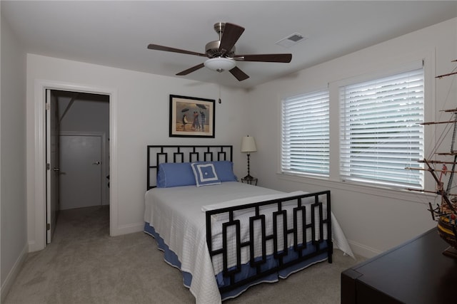 bedroom with ceiling fan and light colored carpet