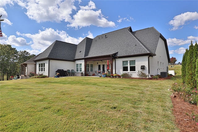 back of property featuring a yard, central AC unit, and ceiling fan