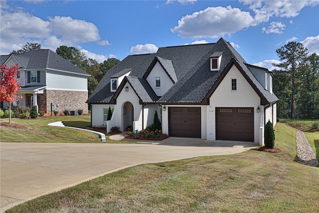 view of front of home with a front lawn and a garage