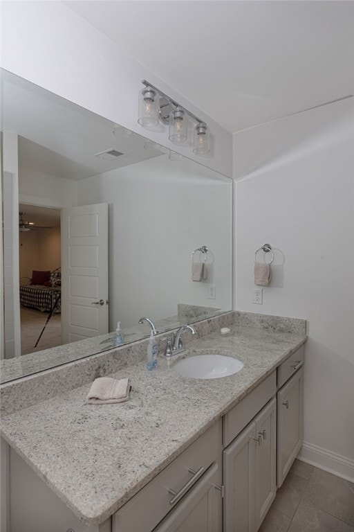 bathroom featuring ceiling fan, tile patterned flooring, and vanity