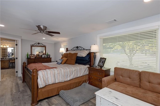 bedroom with ceiling fan and light hardwood / wood-style flooring