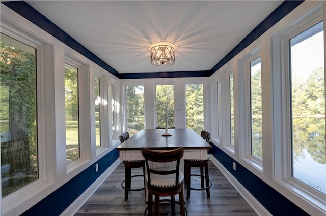 sunroom featuring plenty of natural light and a chandelier