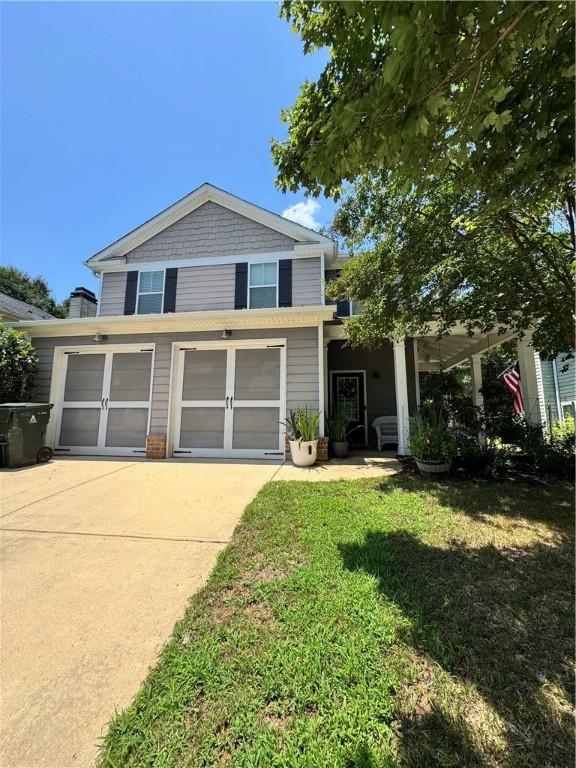 1521 Reynolds Dr, Auburn, AL 36830 - view of front of house featuring driveway, a front yard, and an attached garage