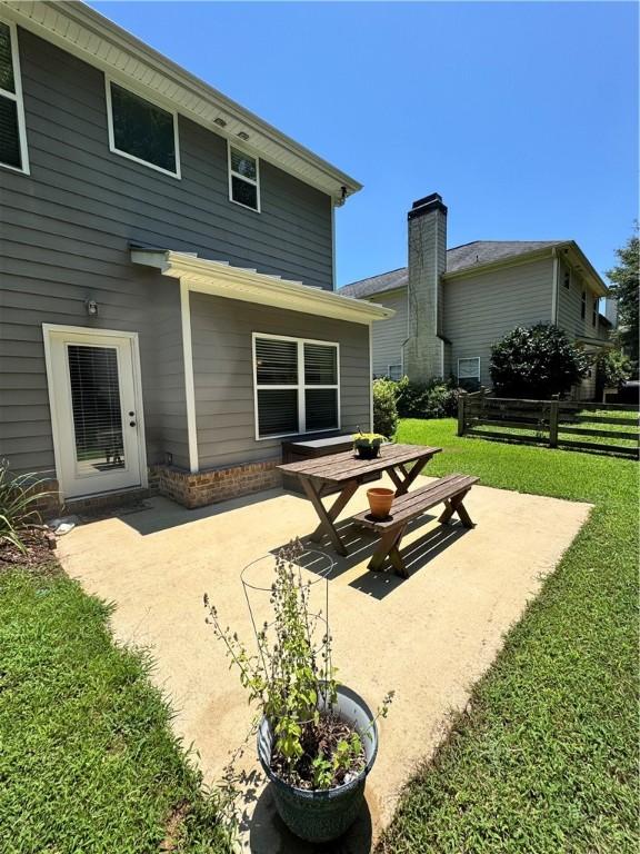 1521 Reynolds Dr, Auburn, AL 36830 - back of house with a patio and a lawn