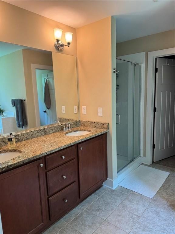 1521 Reynolds Dr, Auburn, AL 36830 - full bath featuring double vanity, a shower stall, and tile patterned flooring