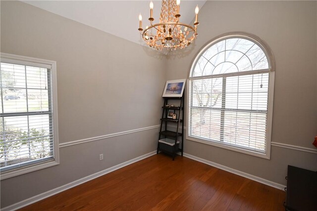 1798 Brookhaven Ct, Auburn, AL 36830 - unfurnished room with a notable chandelier, baseboards, and wood finished floors