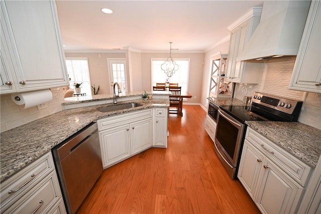 1798 Brookhaven Ct, Auburn, AL 36830 - kitchen with custom exhaust hood, a peninsula, crown molding, stainless steel appliances, and a sink