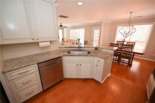 1798 Brookhaven Ct, Auburn, AL 36830 - kitchen featuring light wood-style floors, stainless steel dishwasher, a peninsula, ornamental molding, and a sink