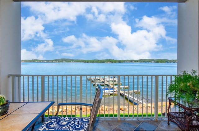 balcony featuring a boat dock and a water view