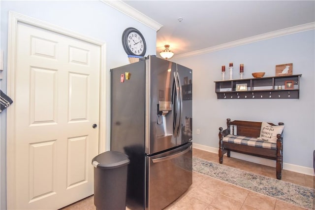 kitchen with stainless steel fridge, ornamental molding, and light tile patterned flooring