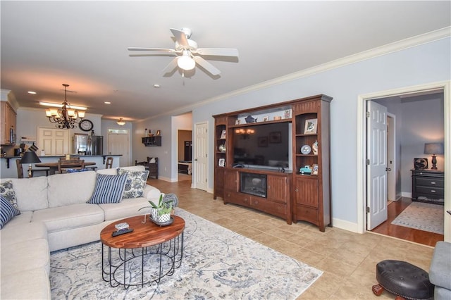 living room with ceiling fan with notable chandelier and ornamental molding