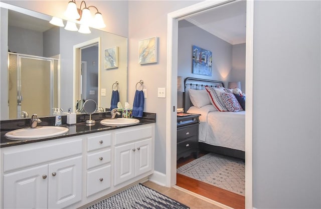 bathroom with tile patterned flooring, vanity, and walk in shower