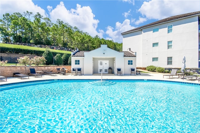 view of swimming pool with a patio area