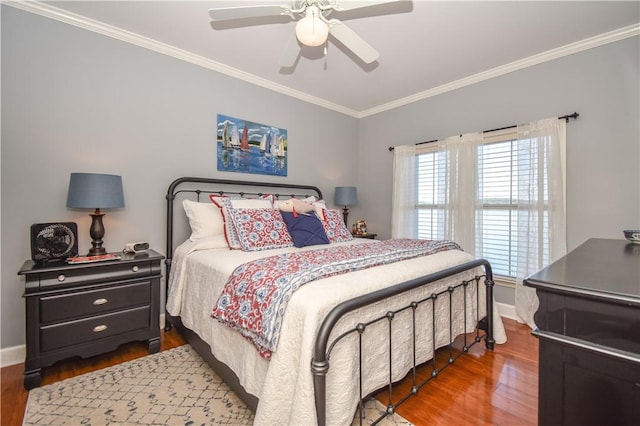 bedroom with ceiling fan, dark hardwood / wood-style flooring, and ornamental molding