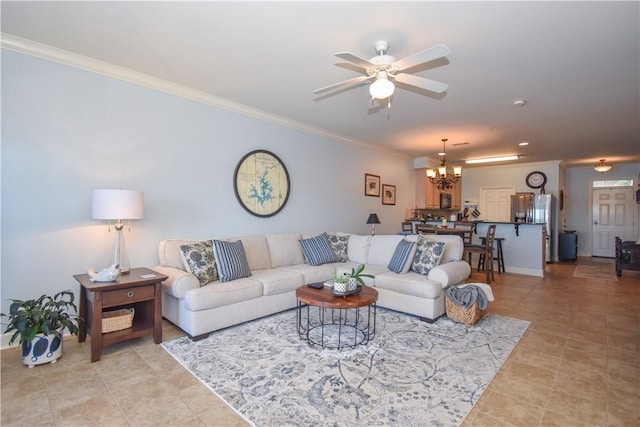 living room featuring ceiling fan with notable chandelier and crown molding