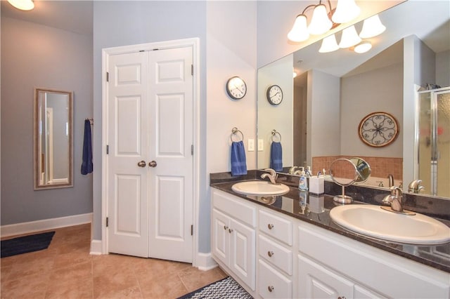 bathroom featuring tile patterned floors, vanity, and a shower with shower door