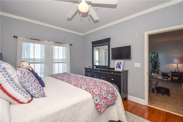 bedroom with ceiling fan, ornamental molding, and dark wood-type flooring