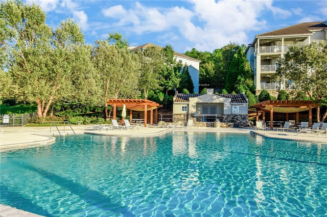 view of swimming pool featuring a patio area and a pergola