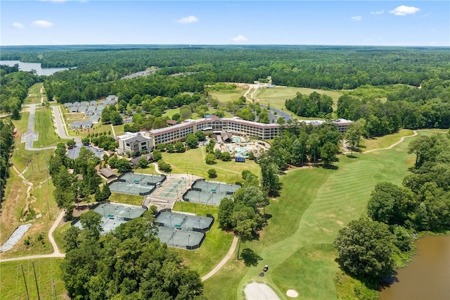 birds eye view of property with view of golf course, a view of trees, and a water view