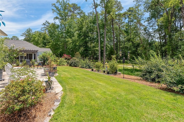 view of yard featuring a patio area, a pergola, and a fire pit