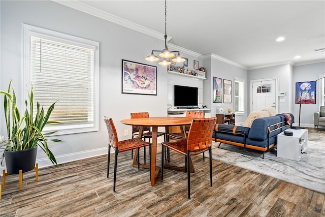 dining area with recessed lighting, crown molding, baseboards, and wood finished floors