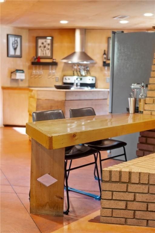 bar with recessed lighting, electric range oven, and wall chimney range hood