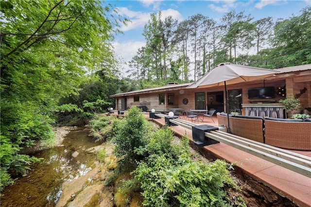 rear view of property featuring an outdoor hangout area