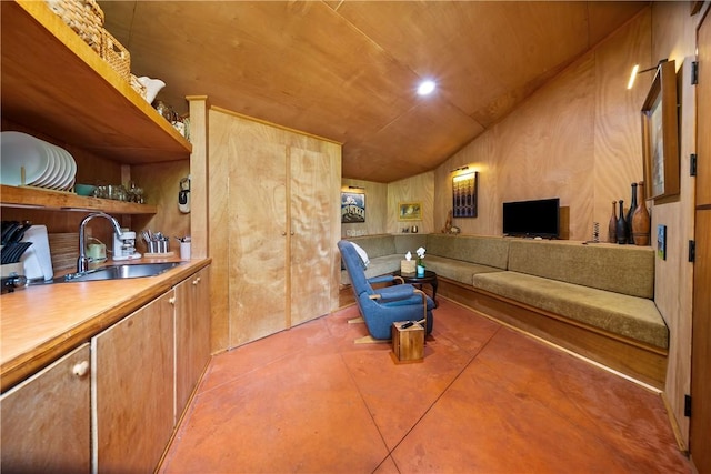 living room with vaulted ceiling and finished concrete floors
