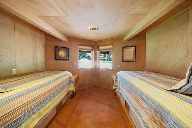bedroom featuring visible vents, wood walls, and wood ceiling