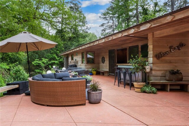 view of patio featuring outdoor dry bar and an outdoor living space