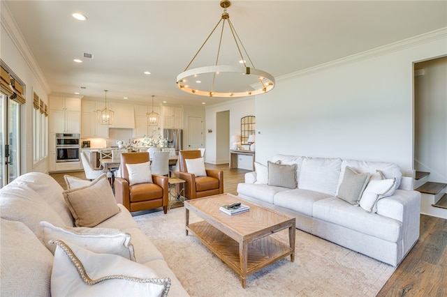 242 Williams Rd, Alexander City, AL 35010 - living room featuring light wood finished floors, a chandelier, ornamental molding, and recessed lighting