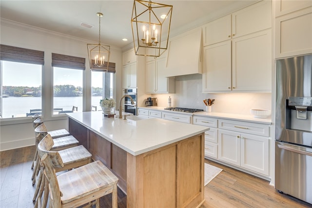 242 Williams Rd, Alexander City, AL 35010 - kitchen featuring stainless steel appliances, a chandelier, light countertops, a kitchen island with sink, and custom exhaust hood