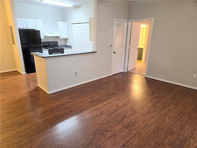 kitchen with exhaust hood, dark hardwood / wood-style floors, kitchen peninsula, white cabinets, and black appliances