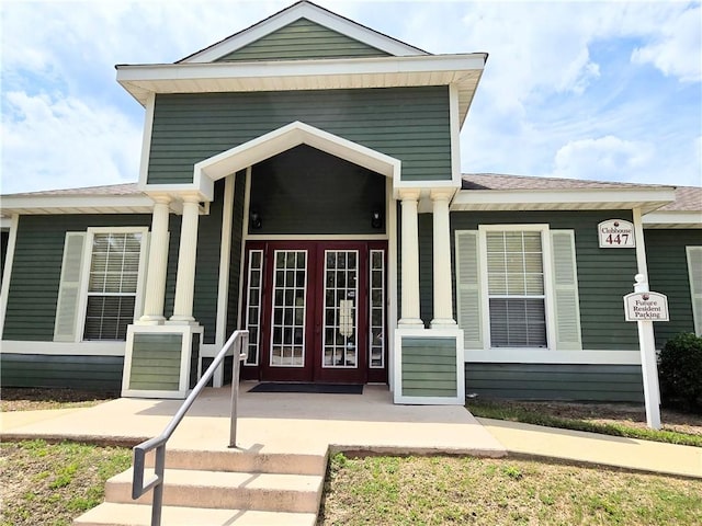 view of exterior entry featuring covered porch