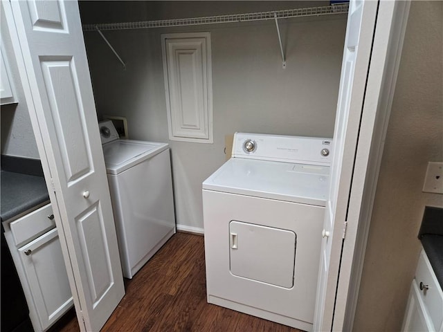 laundry area with cabinets, independent washer and dryer, and dark hardwood / wood-style flooring