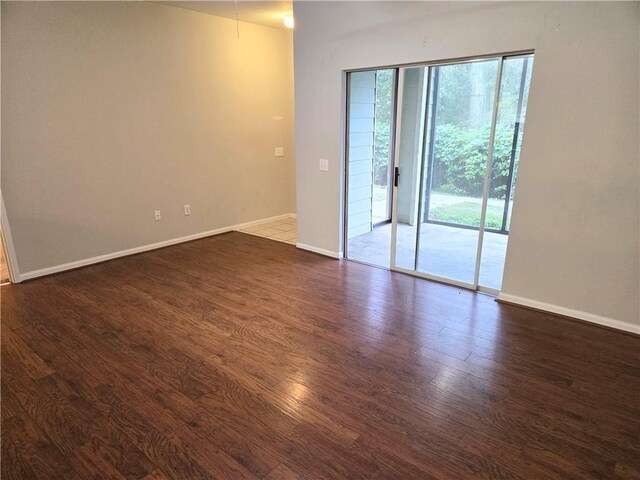 empty room featuring dark hardwood / wood-style flooring