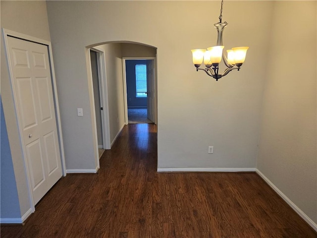 interior space with a notable chandelier and dark hardwood / wood-style floors