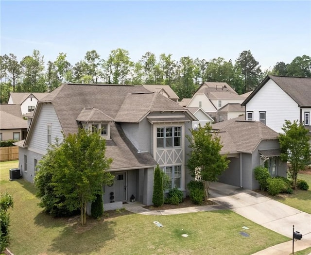 1195 Southridge Ct, Auburn, AL 36830 - view of front of home featuring driveway, cooling unit, a front lawn, and a shingled roof