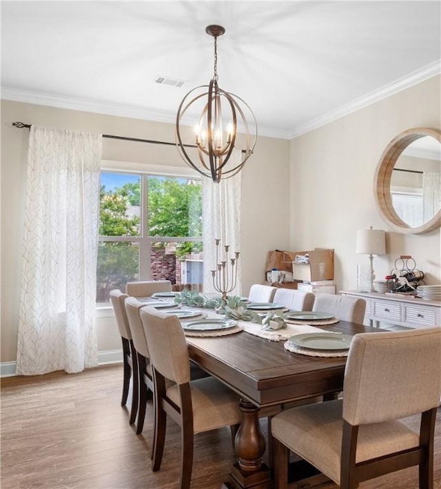 1195 Southridge Ct, Auburn, AL 36830 - dining room featuring a chandelier, ornamental molding, light wood-style flooring, and baseboards