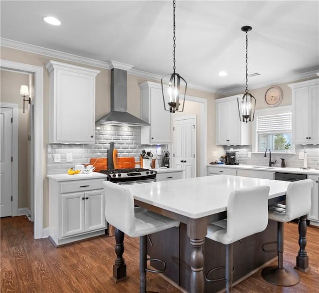 1195 Southridge Ct, Auburn, AL 36830 - kitchen featuring wall chimney exhaust hood, a sink, backsplash, light countertops, and a kitchen bar