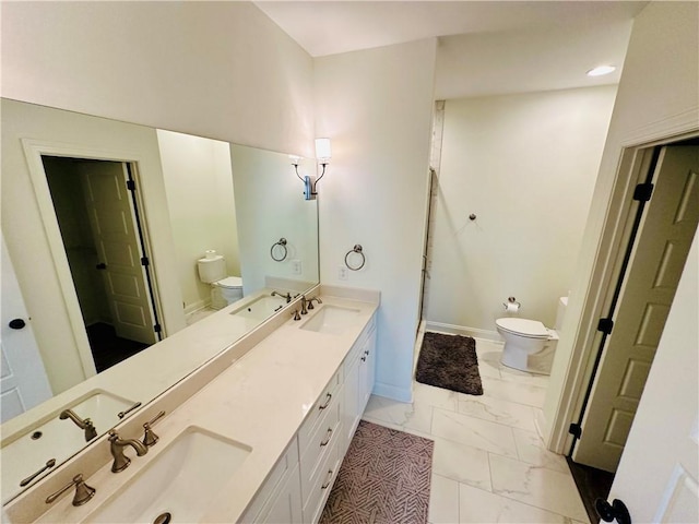 bathroom featuring a sink, toilet, and marble finish floor