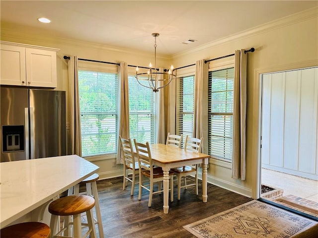 dining room with a notable chandelier, baseboards, visible vents, and dark wood finished floors