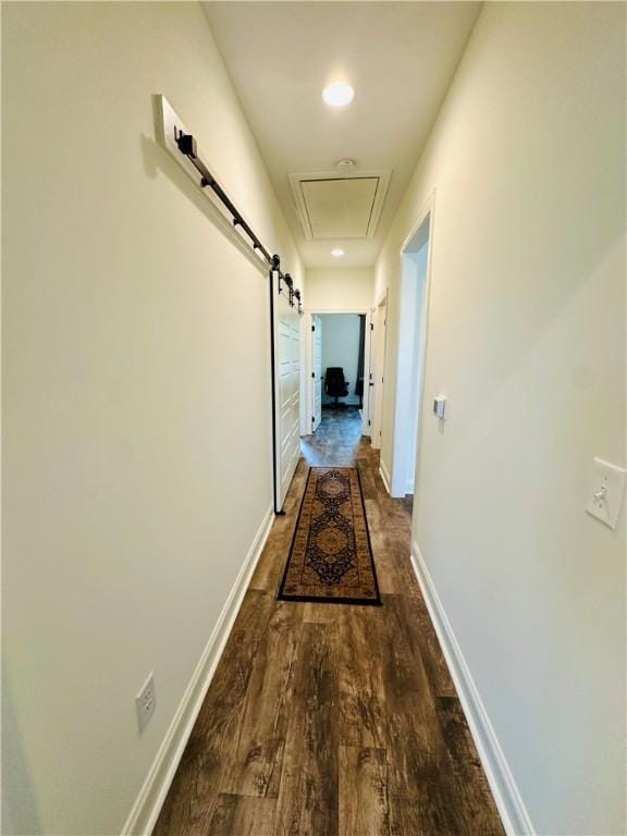 hallway with baseboards and wood finished floors
