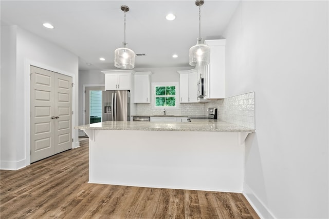 630 Village Dr Unit 15, Opelika, AL 36801 - kitchen with appliances with stainless steel finishes, decorative backsplash, a peninsula, white cabinetry, and recessed lighting