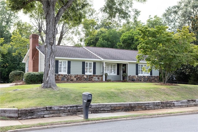 ranch-style home with a front lawn