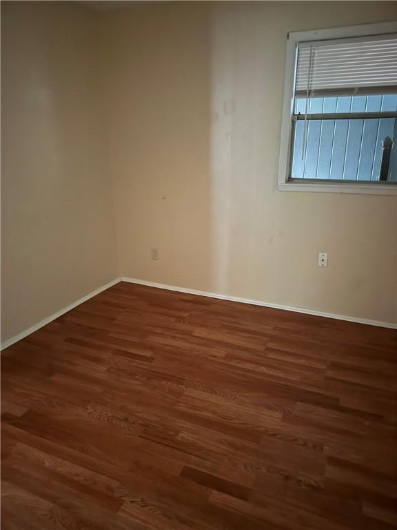 spare room featuring dark hardwood / wood-style floors